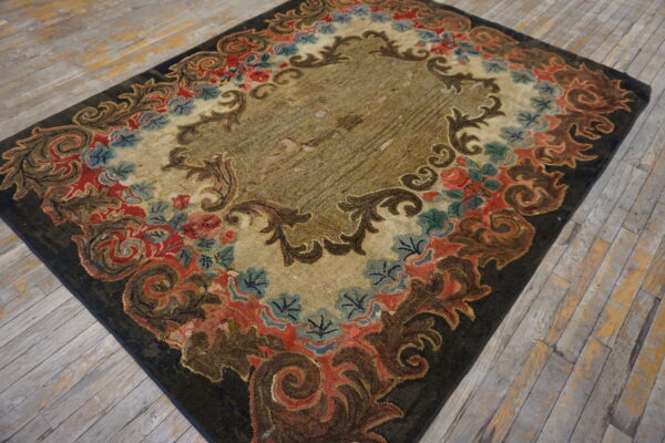 Ornate dark, red, and blue floral rug with a striated khaki center rests on weathered wood planks.