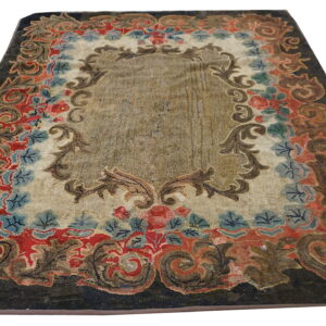 Rectangular rug with a brown center field and a border of colorful floral and scroll patterns on a dark ground.