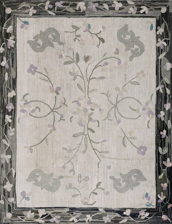 Pale rug with stylized gray motifs and purple floral vines, bordered by dark stripes and flowers.