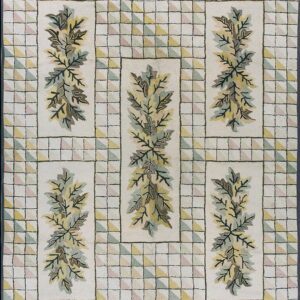 A cream rug featuring a green and yellow foliage design framed by a border of pastel checkered triangles.