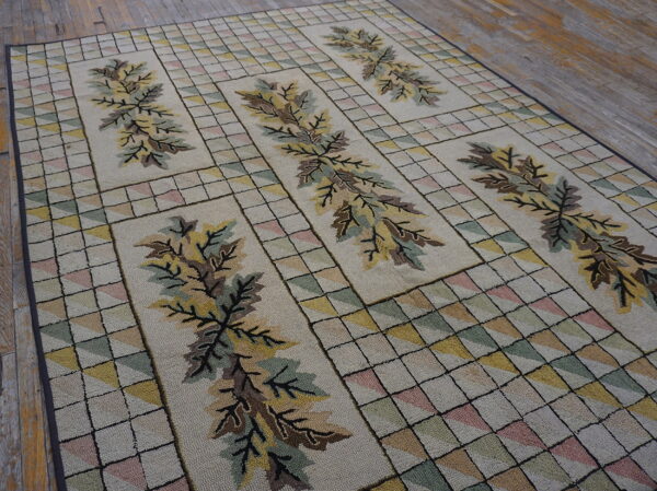 Textured beige rug with brown leaves and multicolored geometric squares rests on rustic wooden floorboards.