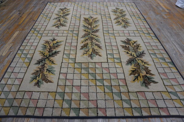 Low-pile rug with repeated foliage designs and pastel triangular grid patterns on wooden flooring.