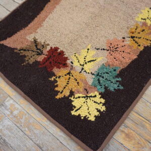 Colorful leaf-patterned vintage hooked rug