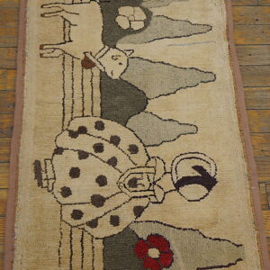 Beige hooked rug with a folk art pattern of a woman, dog, and flowers on a brown wood floor.
