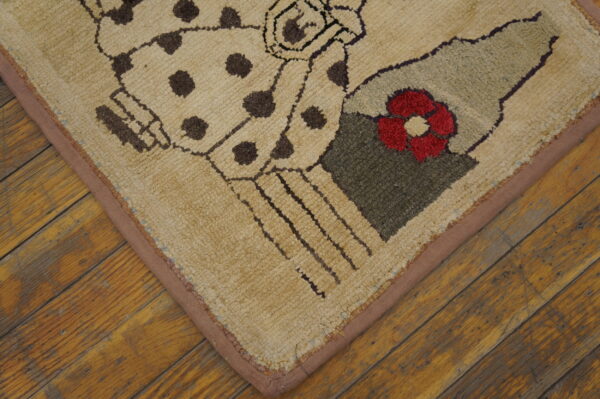 Textured rug with beige, brown, red, and green abstract patterns rests on diagonal distressed wood flooring.