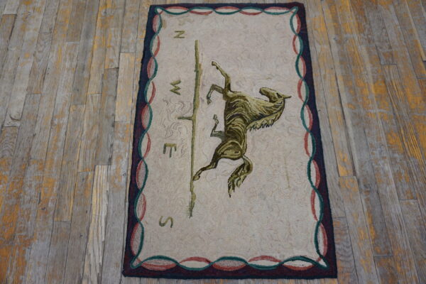 A looped beige rug featuring a central brown and olive horse and compass design on rustic wood plank flooring.
