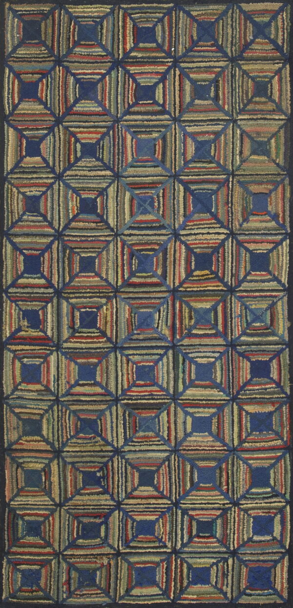 Multicolored hooked rug with a geometric log cabin pattern of striped squares surrounding solid blue centers.