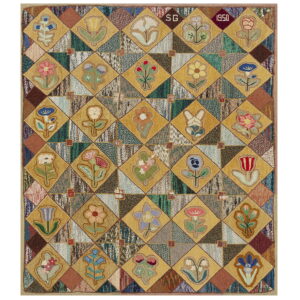 Patchwork rug featuring mustard yellow diamonds with floral designs alternating with multicolored, textured triangular fields.