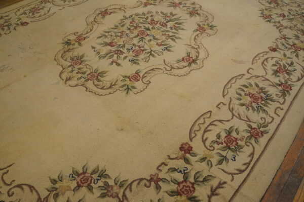 Floral patterned antique hooked rug