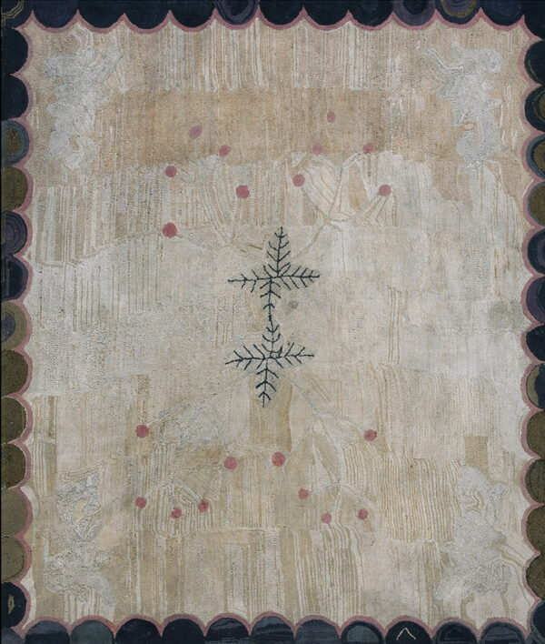 Muted beige rug with striated texture, dark cross centerpiece, pink spots, and a thick scalloped dark border.