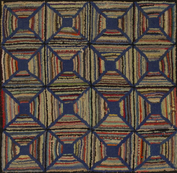 Textured rug with multicolored striped blocks forming a geometric lattice pattern defined by solid blue lines.