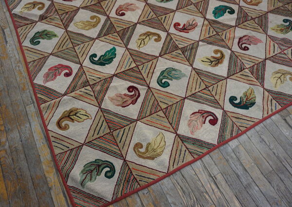 Textured rug with leaf motifs inside cream diamonds and multicolored striped triangles on distressed wood floor.