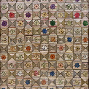 Textured rug with multicolored flowers set inside a geometric striped checkerboard pattern.