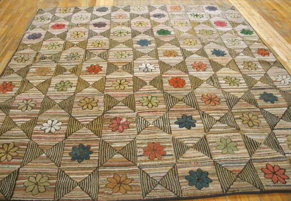 Geometric quilt-patterned rug featuring multicolored flowers set in striped squares on light wood flooring.