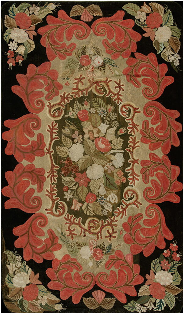 Textured rug featuring coral scrolling leaves and a colorful floral medallion on a dark background.