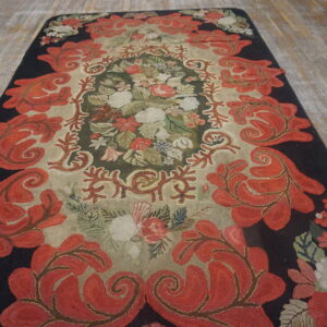 High-pile runner rug with red foliate borders and a densely colored floral center on rustic wooden planks.