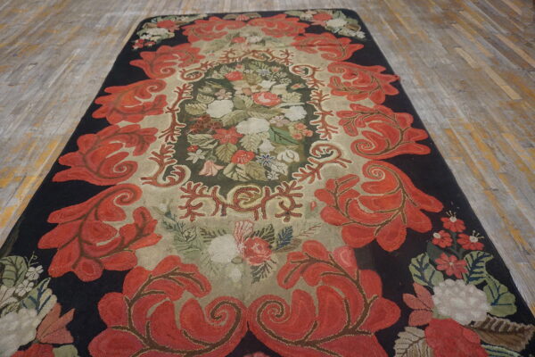 High-pile runner rug with red foliate borders and a densely colored floral center on rustic wooden planks.