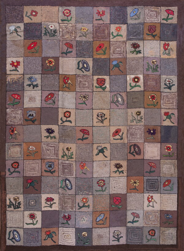 Muted checkerboard rug with a dark border, featuring alternating colorful floral motifs and abstract concentric square designs.