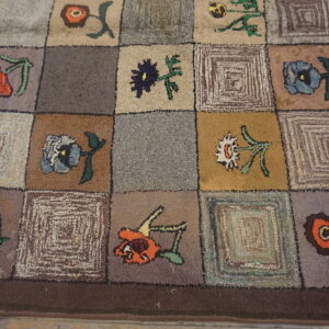 Rustic high-pile rug with a multicolor checkerboard pattern of stylized flowers and abstract squares.