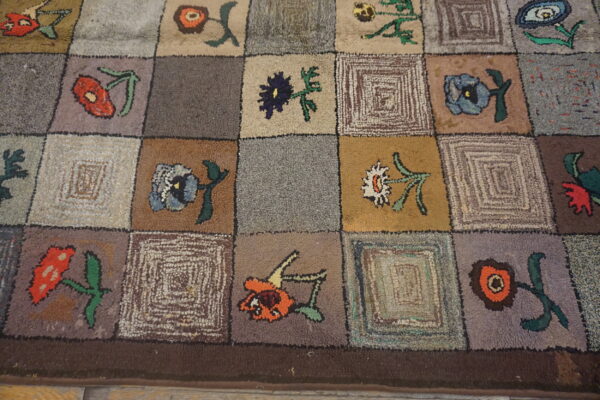 Rustic high-pile rug with a multicolor checkerboard pattern of stylized flowers and abstract squares.