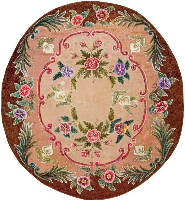 Round dusty rose rug with a dark brown border and ornate multicolored floral and scrolling ribbon designs.