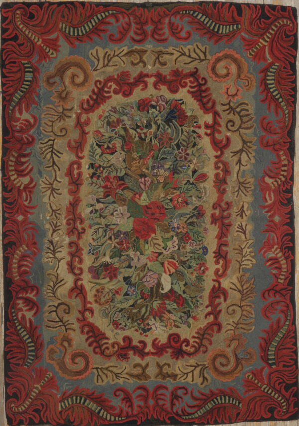 Textured, multicolored rug with a dense floral center and wide, heavily scrolled red and blue ornamental borders.