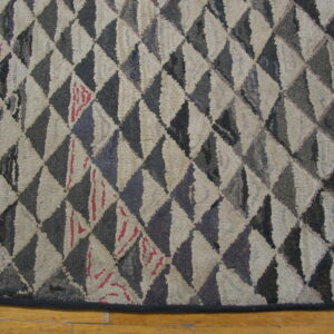 High-texture rug with geometric beige and dark brown triangles displayed on light wooden floorboards.