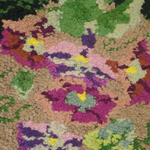 Multicolored high-pile rug detail showing irregular texture blocks of tan, green, purple, magenta, and bright yellow.