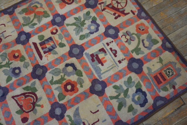 Colorful textured rug featuring floral and novelty squares bordered by purple and coral lattice on wood plank flooring.