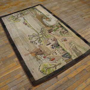 Pictorial rug depicting a village scene and trees with a dark border on rustic wooden floors.