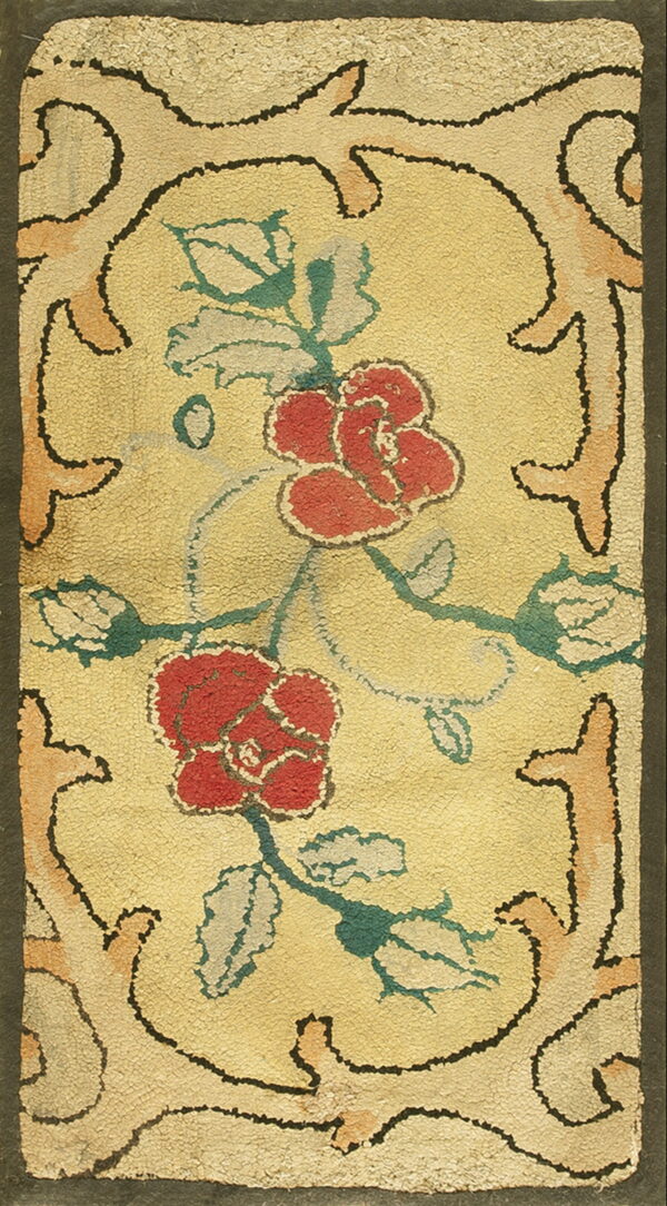 Yellow hooked rug with red roses and teal leaves bordered by black-outlined peach scrollwork.