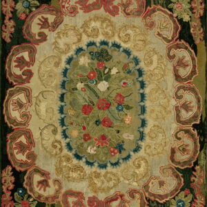 Ornate traditional rug featuring a dense central floral medallion surrounded by scrolling patterns in tan, red, and dark green.