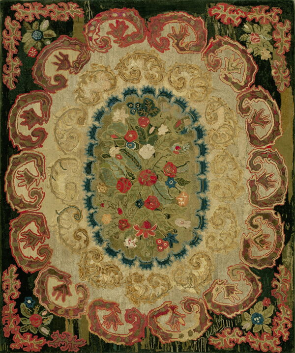 Ornate traditional rug featuring a dense central floral medallion surrounded by scrolling patterns in tan, red, and dark green.