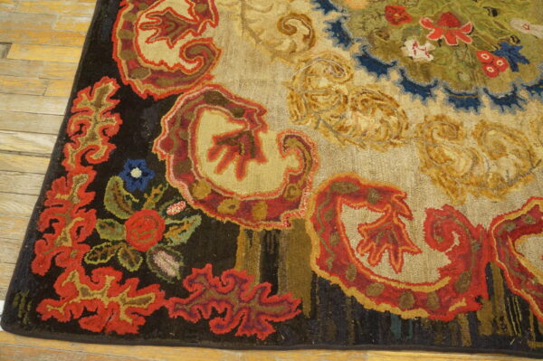 Textured rug featuring large, scrolling floral patterns in red, gold, green, and blue on light wood flooring.