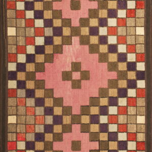 Multi-colored, square-patterned rug with dark borders and a prominent pink geometric motif at the center.