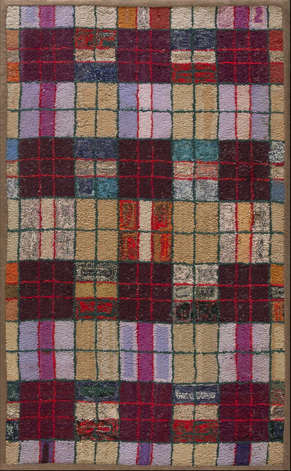 A chunky multicolored rug with a plaid grid pattern of purple, maroon, beige, and red squares.
