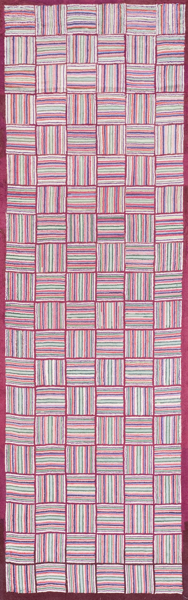 Textured runner rug featuring a magenta grid enclosing blocks of alternating horizontal and vertical colorful stripes.