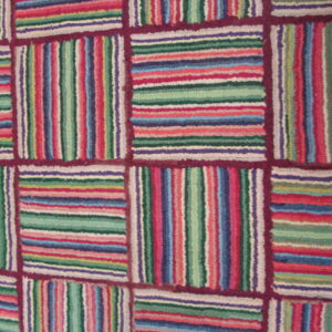 Textured rug with alternating blocks of colorful vertical and horizontal stripes framed by burgundy lines.