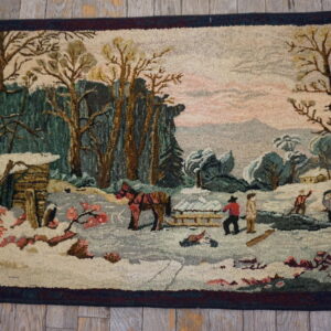 Hooked rug depicting a snowy winter landscape with trees, figures, and a pink sky on wood flooring.