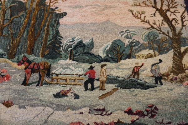 A loop-pile pictorial rug features a snowy scene with trees, figures, and a brown horse.
