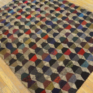 A colorful, textured rug featuring a high-pile 3D diamond block pattern rests on light wood floors.