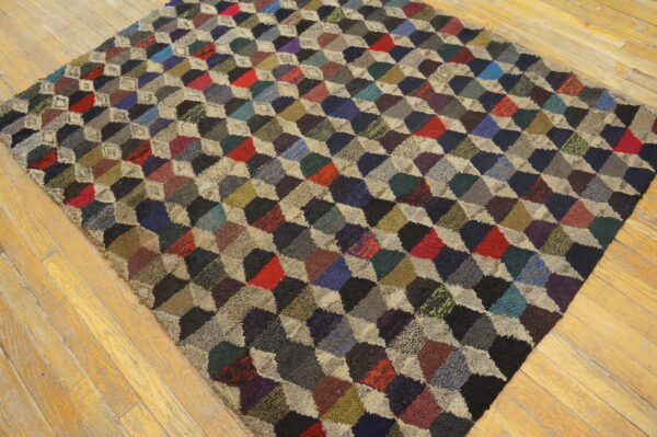 A colorful, textured rug featuring a high-pile 3d diamond block pattern rests on light wood floors.