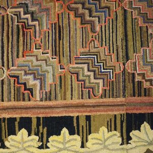 Highly textured rug with multicolored vertical stripes, orange zig-zags, and a yellow leaf border motif.