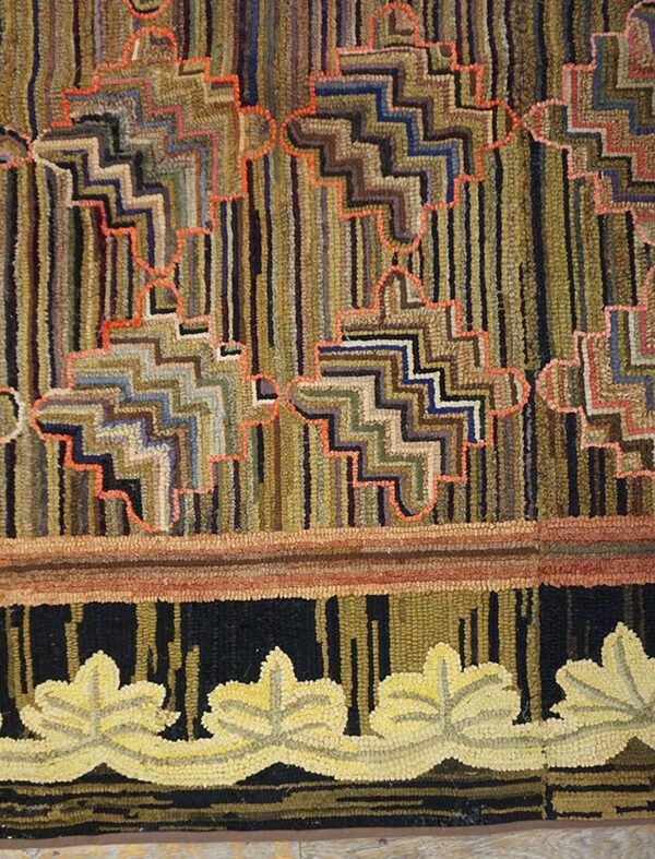 Highly textured rug with multicolored vertical stripes, orange zig-zags, and a yellow leaf border motif.