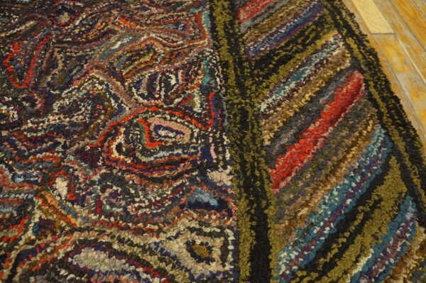 Multicolor textured rug detail featuring abstract swirls and strong diagonal stripes on wood floorboards.