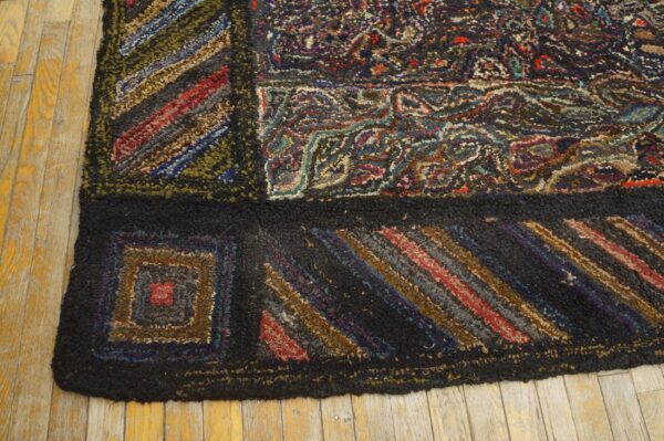 Dark, textured rug featuring block patterns, colorful stripes, and abstract designs against yellow wood planks.