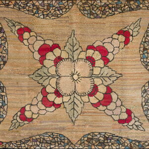 Hooked rug with a beige and red floral design, sage leaves, and a multi-colored fragmented border.