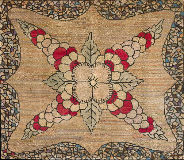Hooked rug with a beige and red floral design, sage leaves, and a multi-colored fragmented border.