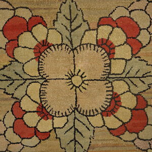 Close-up of a textured beige rug with large red, khaki, and sage floral motifs outlined in black.