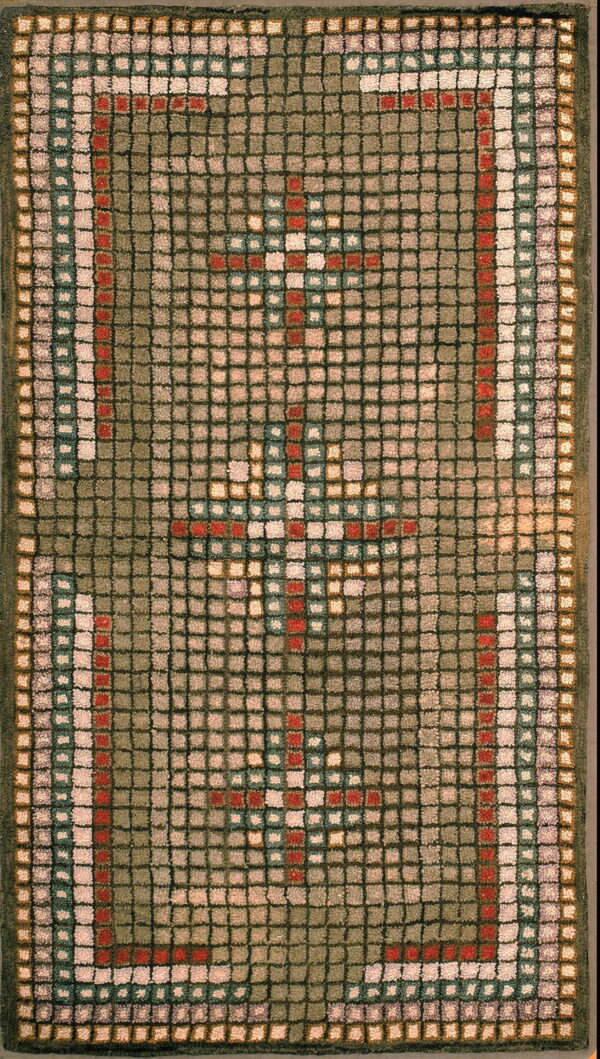 Olive green high-pile rug with a square grid pattern featuring two red and cream geometric crosses.